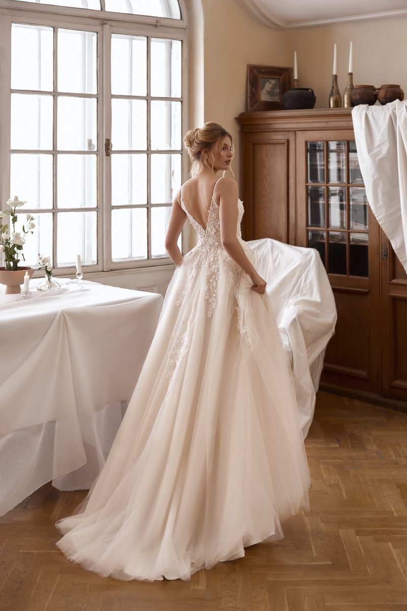 Wedding dress, a-line or ball-gown volume, delicate lace, V-neck corset and a slit — the Lovia model, MADAMOON showroom, Paris 10e